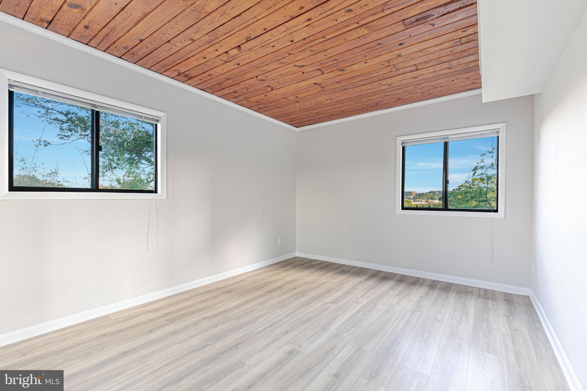53 Skyhill Road, Unit 303 Alexandria, VA 22314 - Photo 12 of 22 an empty room with wooden floor and windows