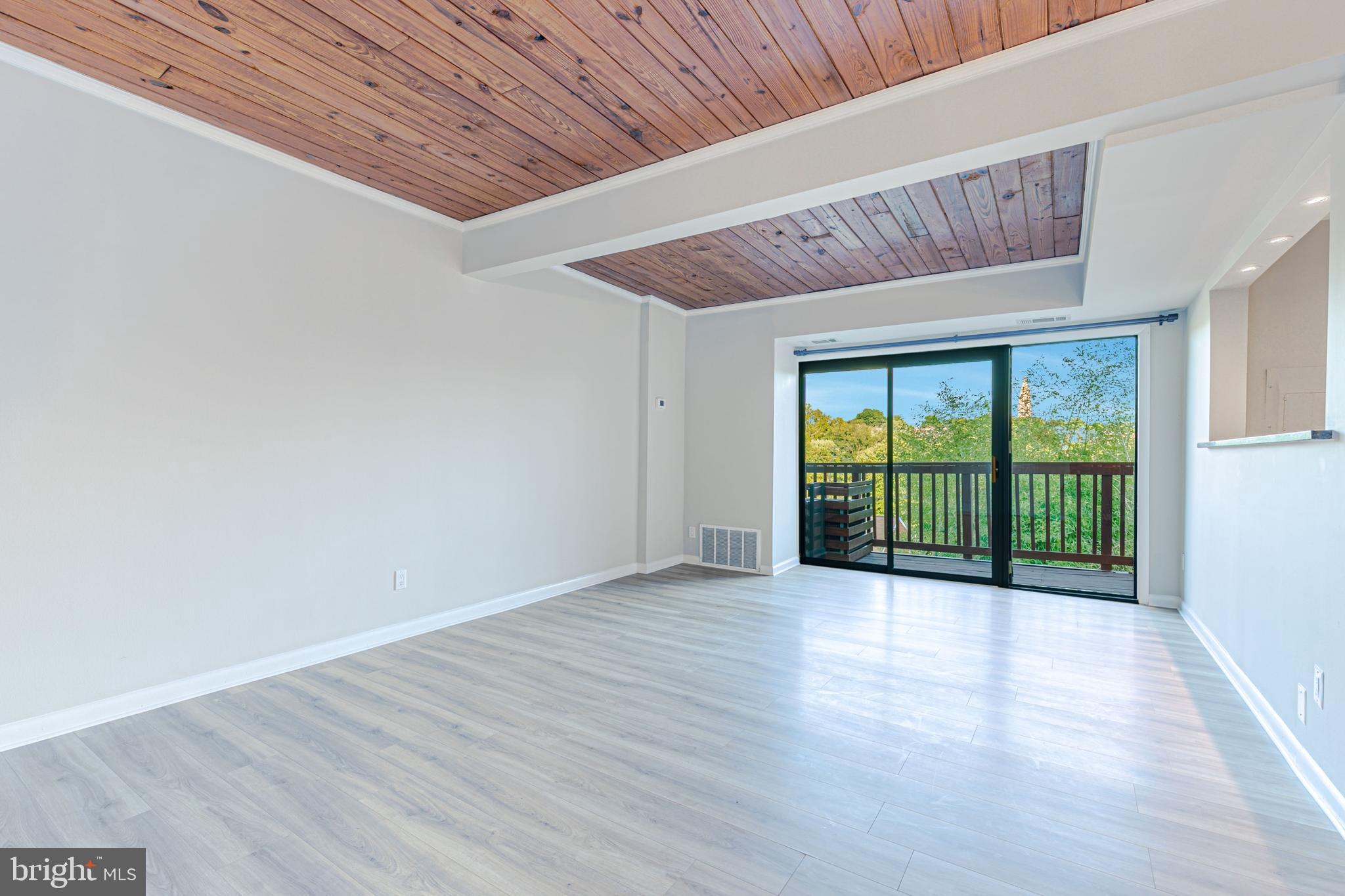 53 Skyhill Road, Unit 303 Alexandria, VA 22314 - Photo 5 of 22 a view of an empty room with wooden floor and a window