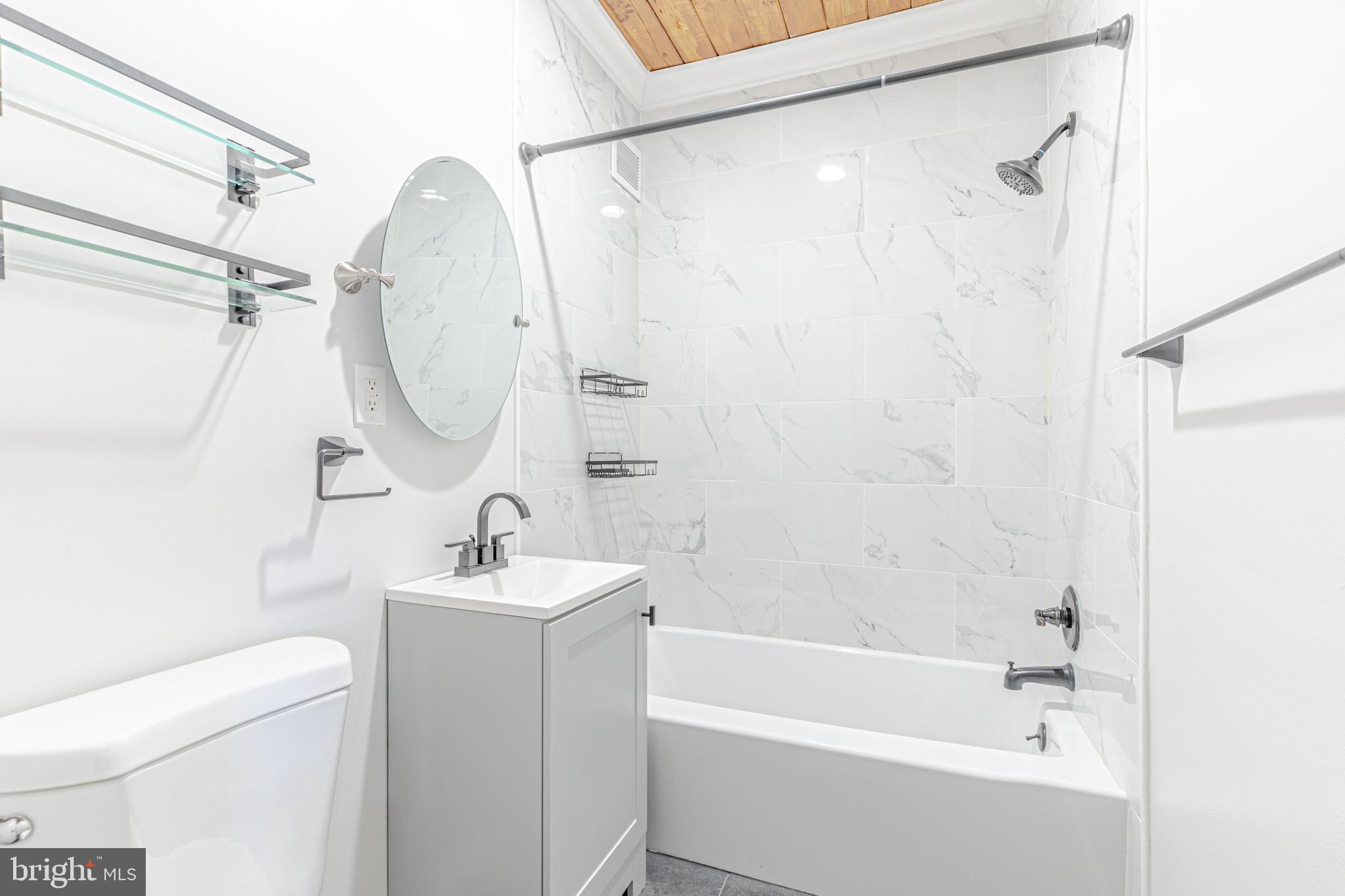 53 Skyhill Road, Unit 303 Alexandria, VA 22314 - Photo 10 of 22 a bathroom with a sink a mirror toilet and bathtub
