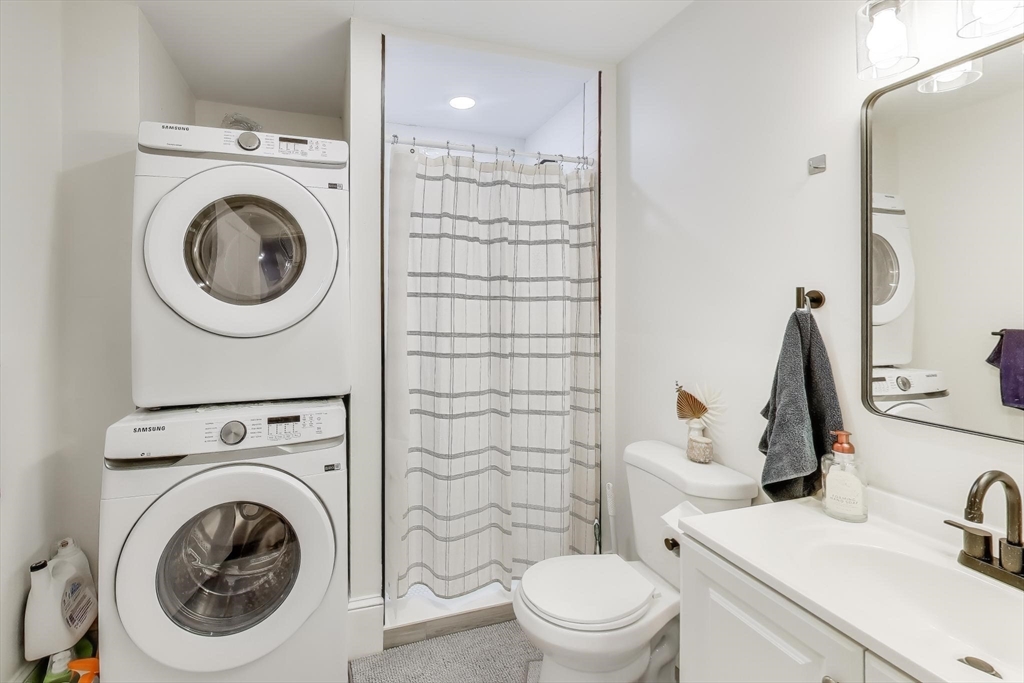 65 Lambert Avenue Boston, MA 02119 - Photo 15 of 42 a bathroom with a sink a toilet and a mirror