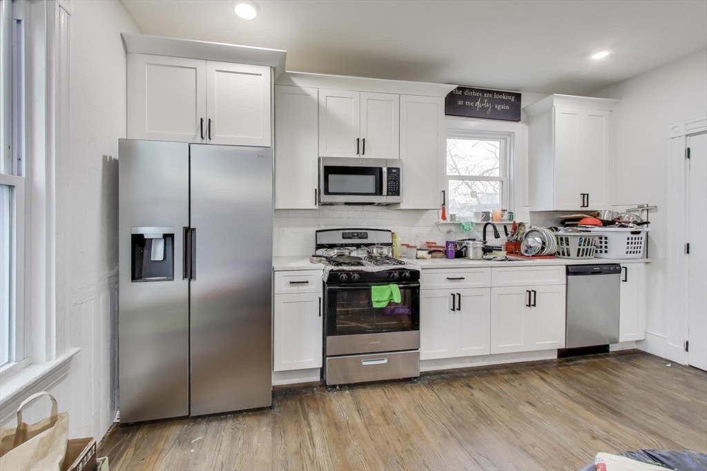 65 Lambert Avenue Boston, MA 02119 - Photo 20 of 42 a kitchen with stainless steel appliances a refrigerator sink and microwave
