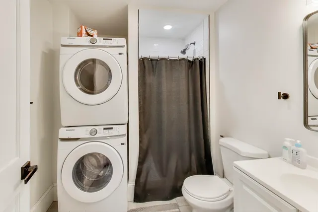 a bathroom with a sink a toilet and a mirror