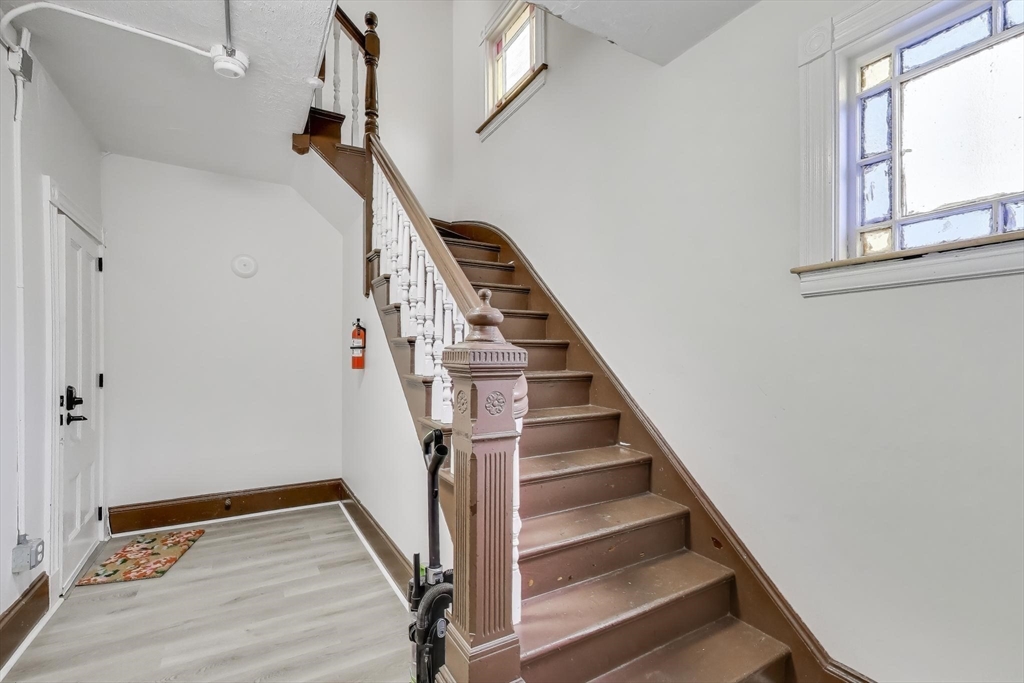 65 Lambert Avenue Boston, MA 02119 - Photo 3 of 42 a view of entryway with wooden floor and stairs