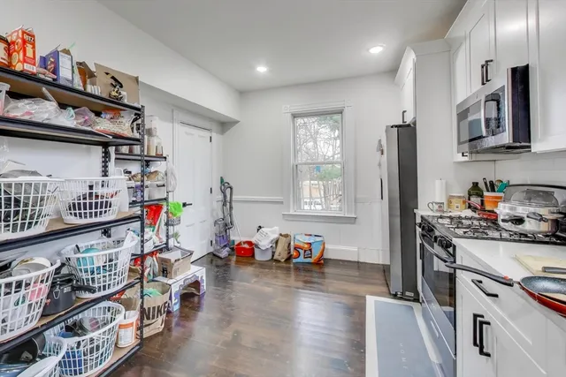 a kitchen with lots of clutter and stainless steel appliances
