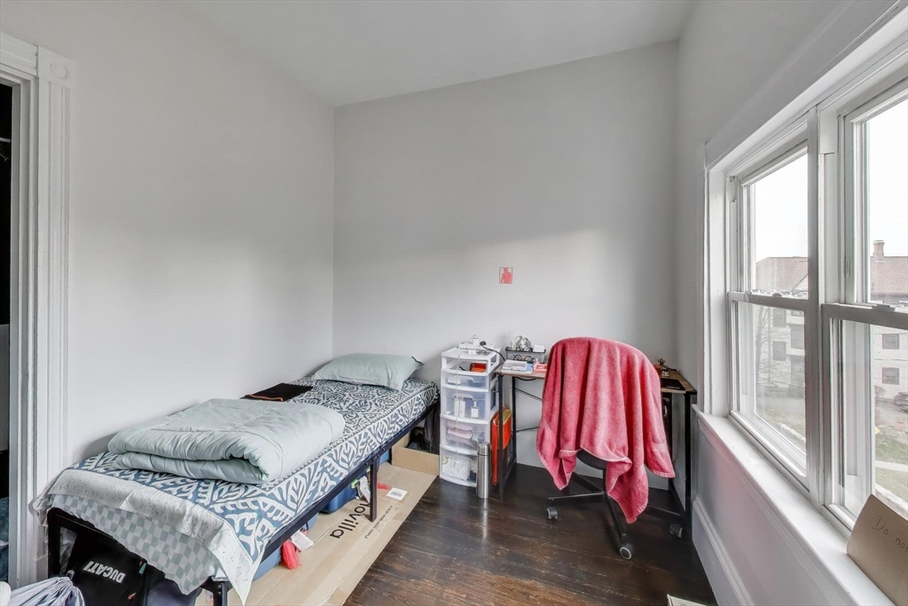 65 Lambert Avenue Boston, MA 02119 - Photo 34 of 42 a bedroom with a bed and a window