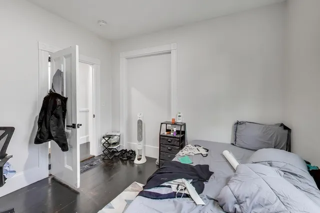 a bedroom with furniture and a flat screen tv