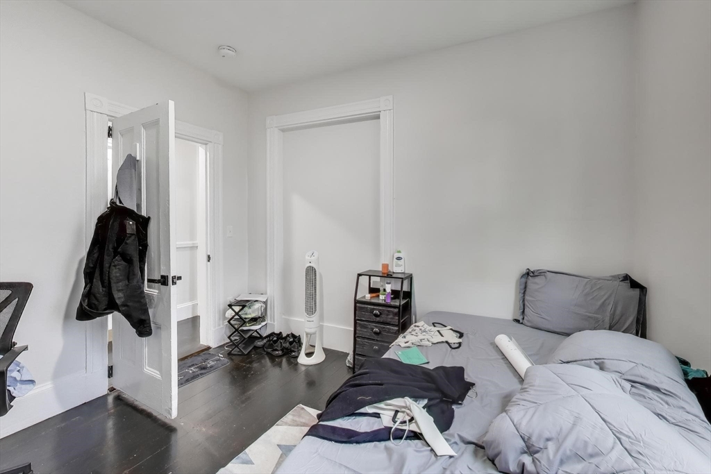 65 Lambert Avenue Boston, MA 02119 - Photo 35 of 42 a bedroom with furniture and a flat screen tv