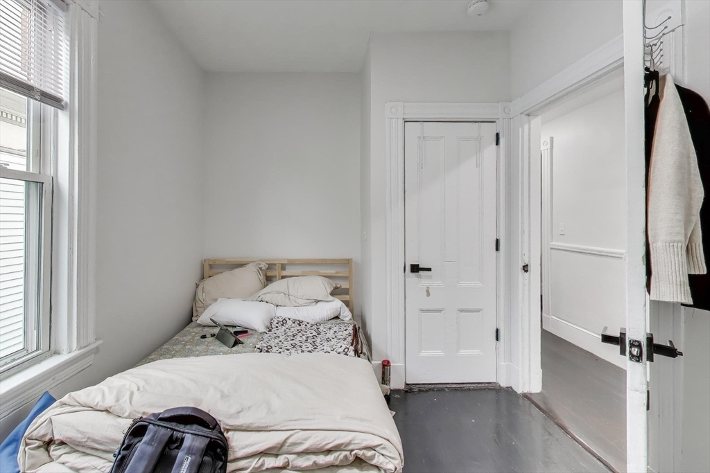 65 Lambert Avenue Boston, MA 02119 - Photo 37 of 42 a bedroom with a bed and a window