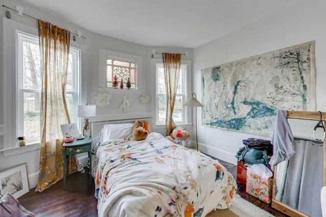 a bed sitting in a bedroom next to a window