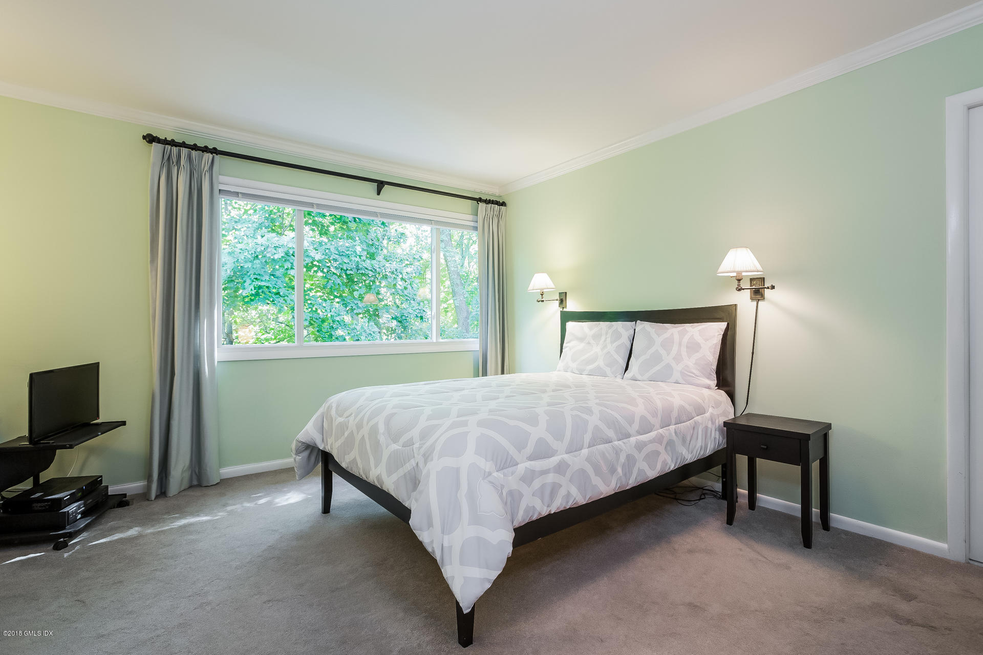 52 Stirrup Lane, Unit 52 Riverside, CT 06878 - Photo 11 of 30 a bed sitting in a bedroom next to a window