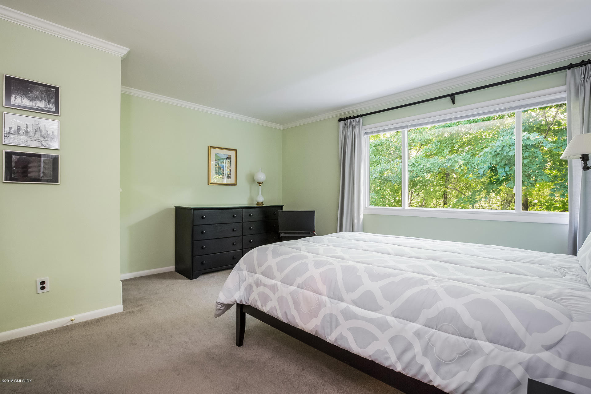 52 Stirrup Lane, Unit 52 Riverside, CT 06878 - Photo 12 of 30 a bedroom with a bed dresser and a window