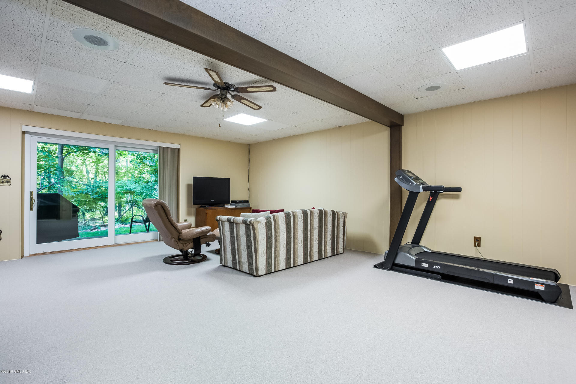 52 Stirrup Lane, Unit 52 Riverside, CT 06878 - Photo 17 of 30 a living room with furniture gym equipment and a large window