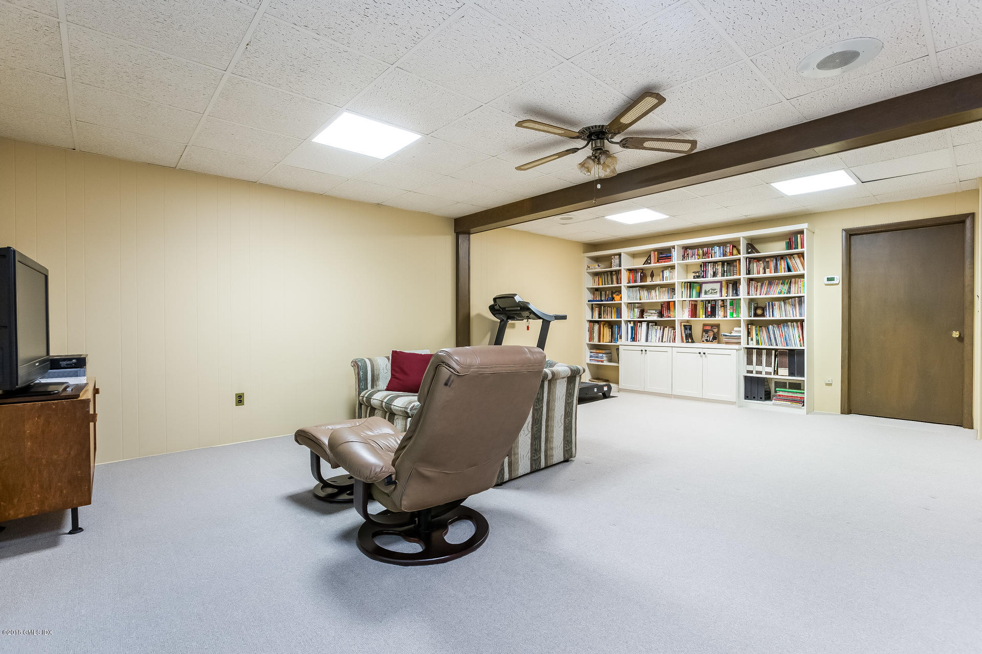 52 Stirrup Lane, Unit 52 Riverside, CT 06878 - Photo 18 of 30 a living room with furniture and a flat screen tv