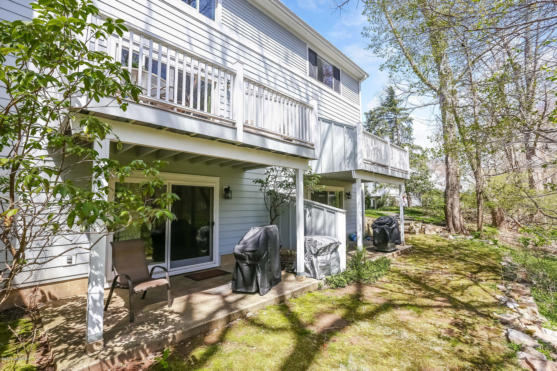 52 Stirrup Lane, Unit 52 Riverside, CT 06878 - Photo 20 of 30 a view of a building with a patio
