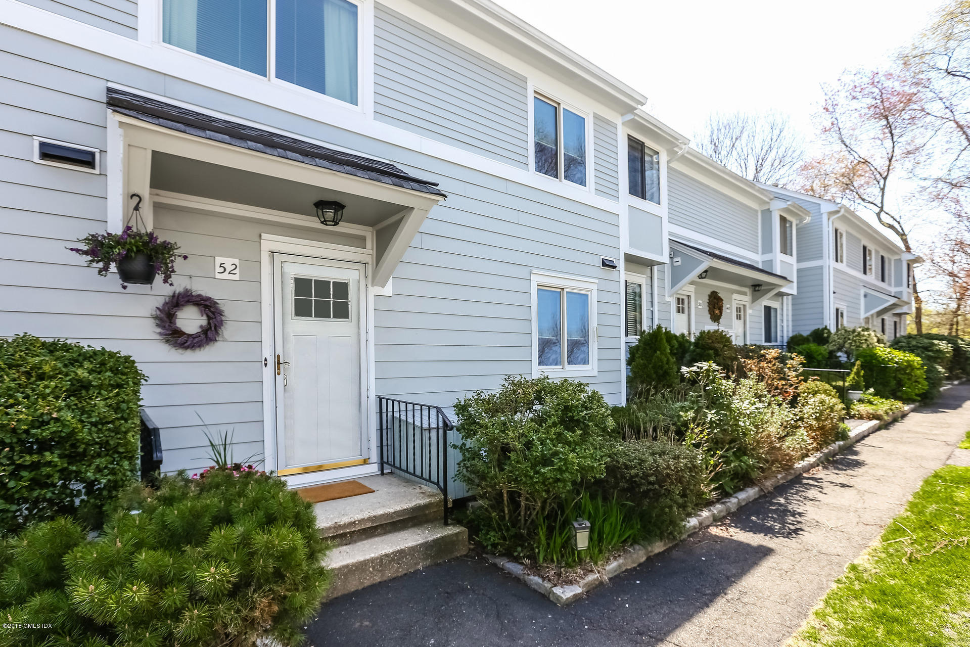 52 Stirrup Lane, Unit 52 Riverside, CT 06878 - Photo 3 of 30 a front view of a house with a garden