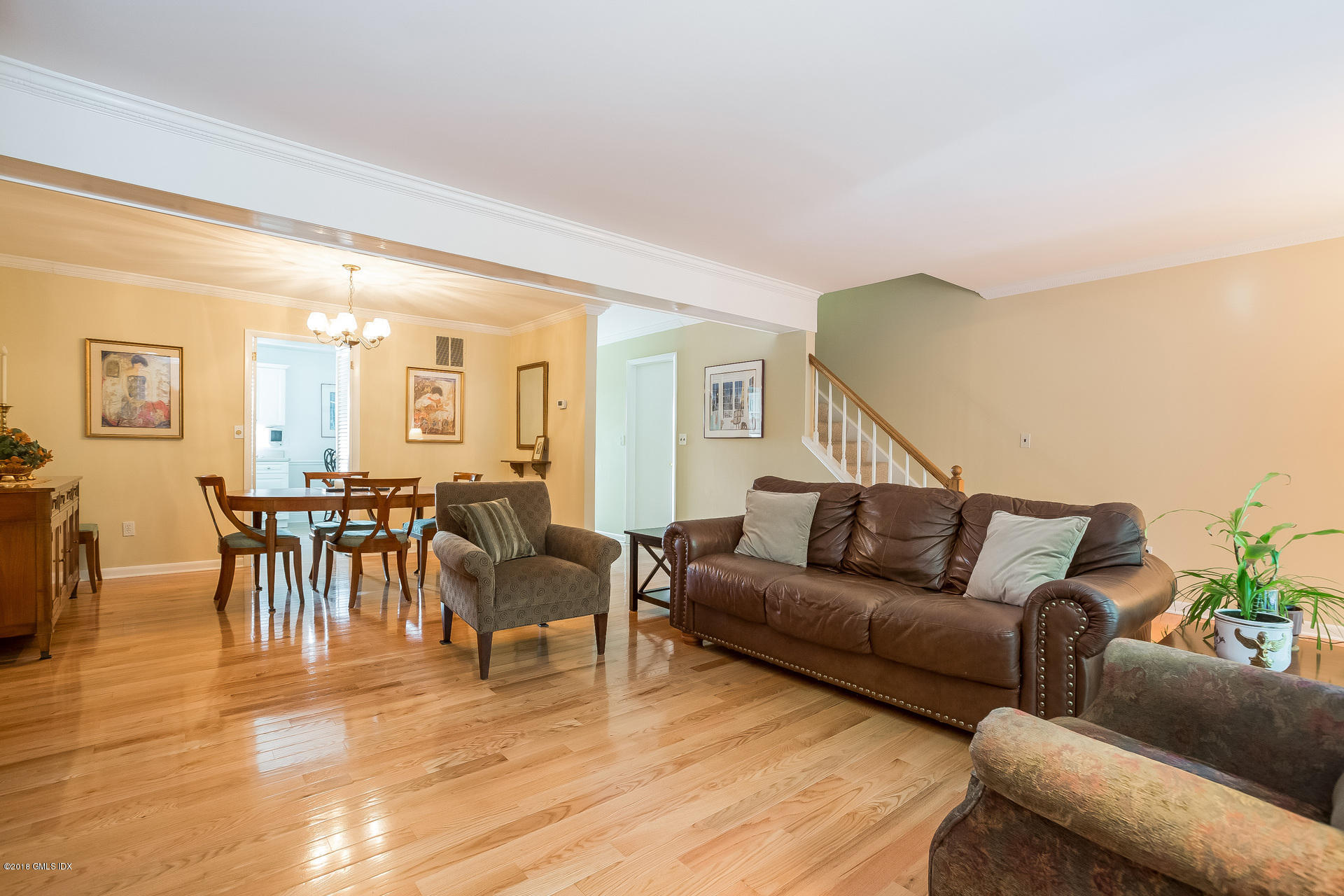 52 Stirrup Lane, Unit 52 Riverside, CT 06878 - Photo 5 of 30 a living room with furniture and a dining table with wooden floor