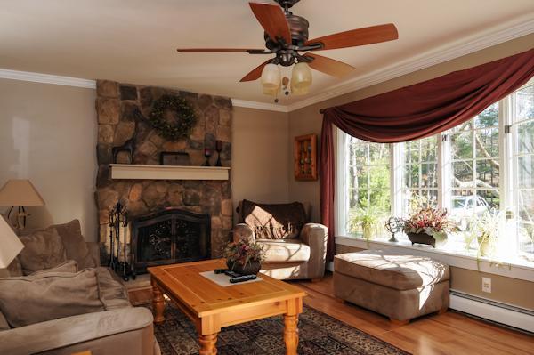 435 Walnut Plain Road Rochester, MA 02770 - Photo 5 of 8 a living room with furniture and a fireplace