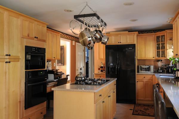 435 Walnut Plain Road Rochester, MA 02770 - Photo 6 of 8 a kitchen with stainless steel appliances granite countertop a refrigerator a stove a sink dishwasher and a refrigerator with wooden floor
