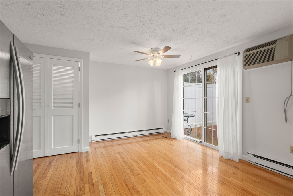 6 Keegan Lane, Unit E Greenfield, MA 01301 - Photo 12 of 29 an empty room with wooden floor and a ceiling fan