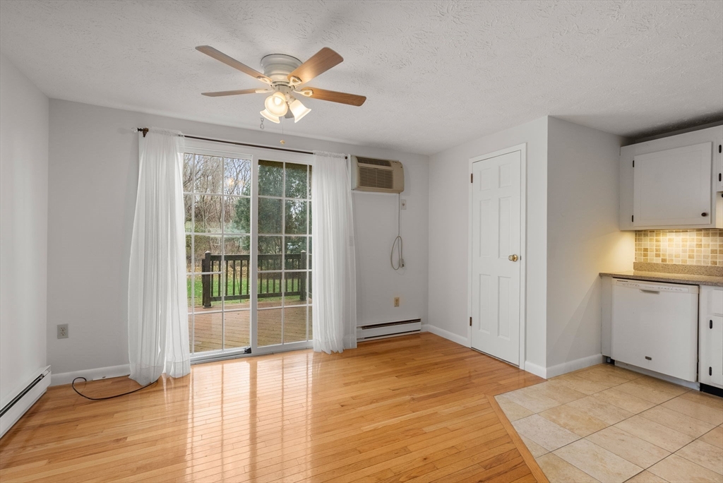 6 Keegan Lane, Unit E Greenfield, MA 01301 - Photo 13 of 29 a view of an empty room with window and wooden floor