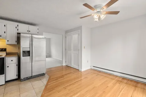 a view of a kitchen with refrigerator and cabinet
