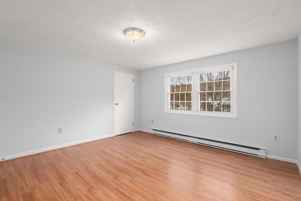6 Keegan Lane, Unit E Greenfield, MA 01301 - Photo 19 of 29 wooden floor in an empty room with a window