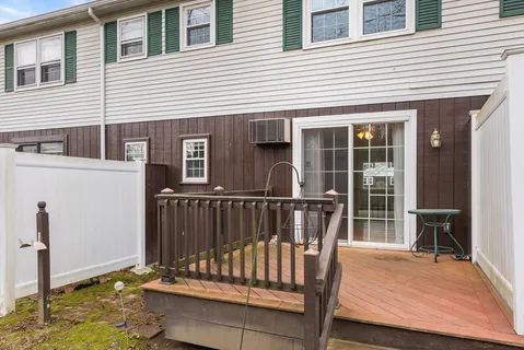 a view of deck with a chair and floor to ceiling window