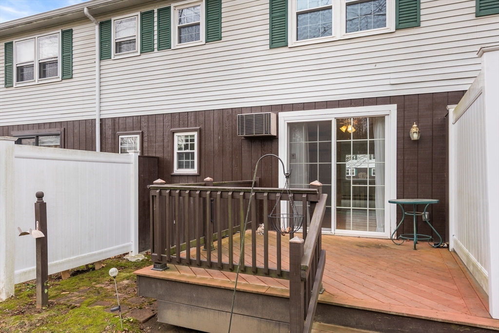 6 Keegan Lane, Unit E Greenfield, MA 01301 - Photo 25 of 29 a view of deck with a chair and floor to ceiling window