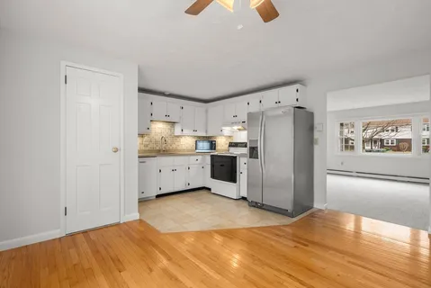 a kitchen with stainless steel appliances a refrigerator and a stove top oven