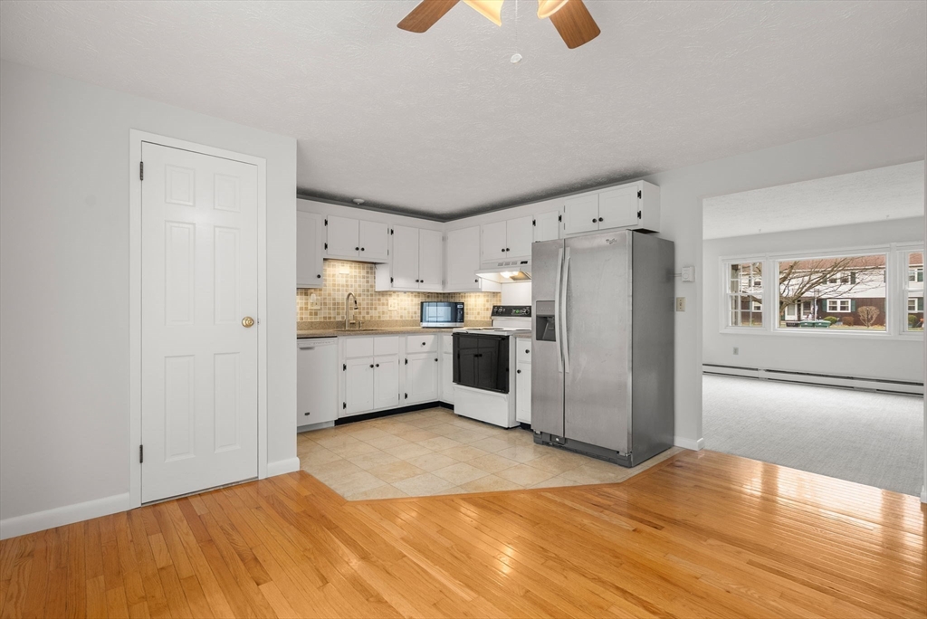 6 Keegan Lane, Unit E Greenfield, MA 01301 - Photo 8 of 29 a kitchen with stainless steel appliances a refrigerator and a stove top oven