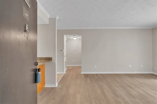 a view of a hallway with wooden floor