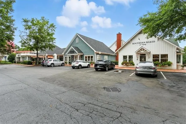 a view of building with cars parked in front of it