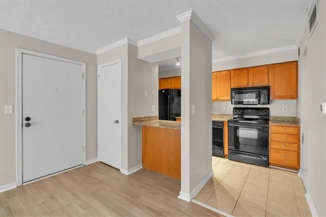 a kitchen with a refrigerator and a stove