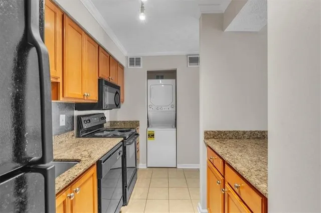 a kitchen with a stove a sink and a refrigerator
