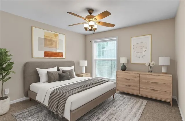 a bedroom with a large bed and a chandelier