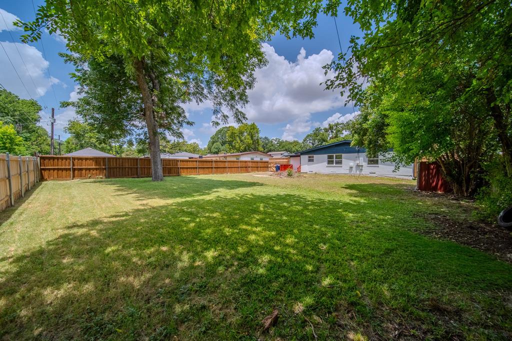 920 Treasure Road Garland, TX 75041 - Photo 17 of 19 a view of yard with swimming pool and trees