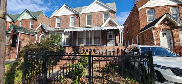 a view of a brick house with large windows