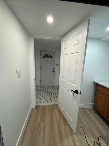 a white toilet sitting next to a sink and vanity