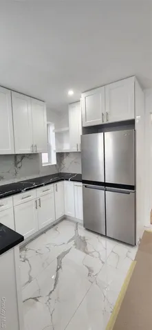 a stove top oven sitting inside of a kitchen