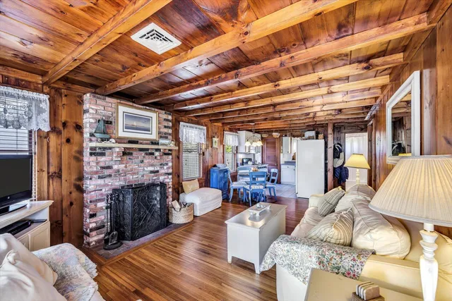 a living room with furniture and wooden floors