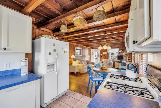 a view of a dining room with furniture and a chandelier