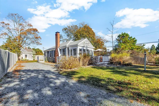 a view of a house with a yard and sitting area