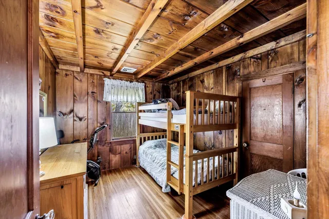 a bedroom with a bed next to a window with outer view