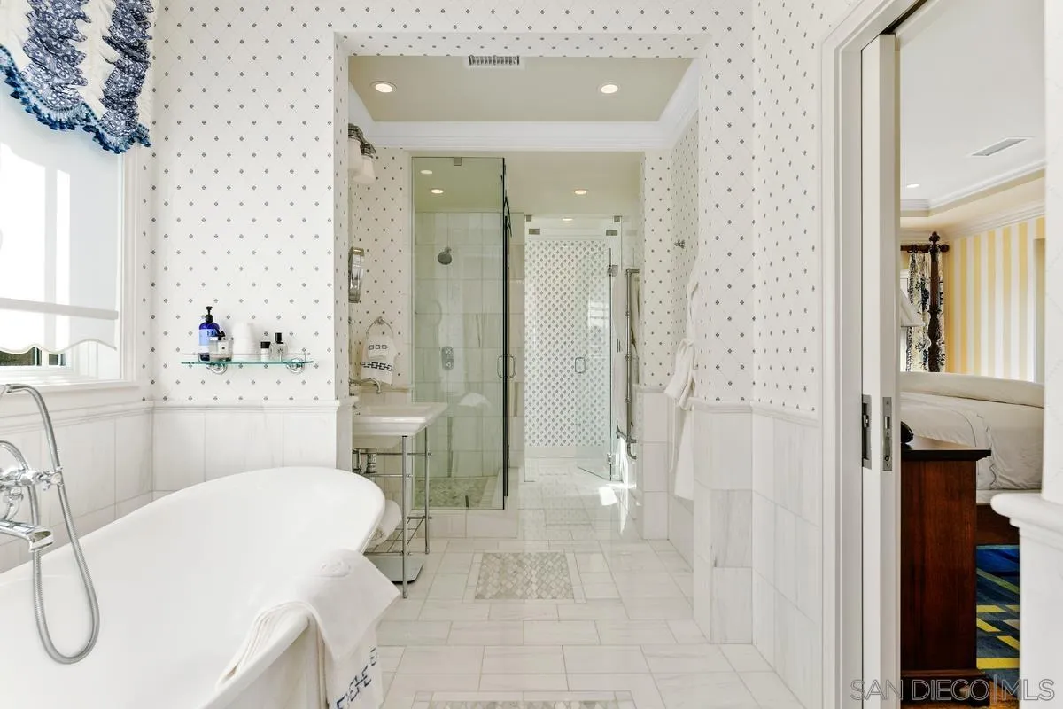 2254 Del Mar Heights Road Del Mar, CA 92014 - Photo 22 of 34 a bathroom with a tub shower sink and a mirror