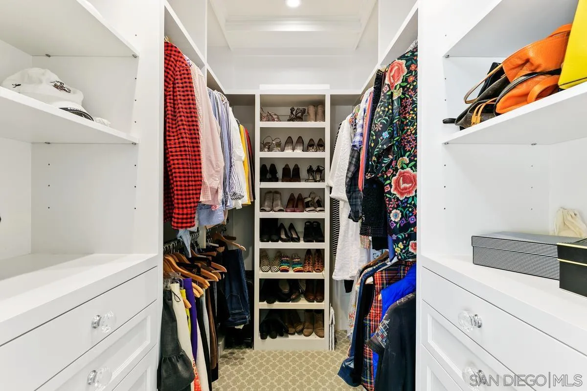 2254 Del Mar Heights Road Del Mar, CA 92014 - Photo 24 of 34 a view of walk in closet with clothes and shoes