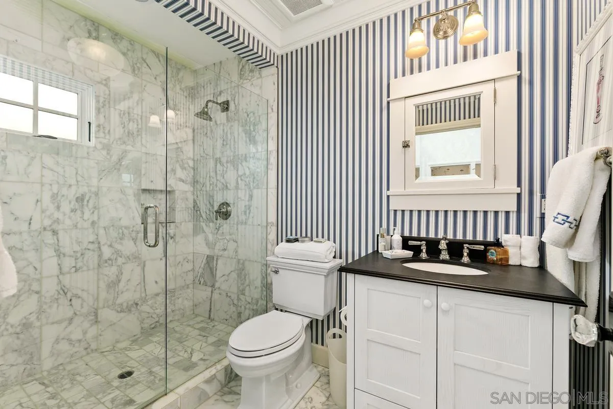2254 Del Mar Heights Road Del Mar, CA 92014 - Photo 29 of 34 a bathroom with a sink toilet a mirror and shower