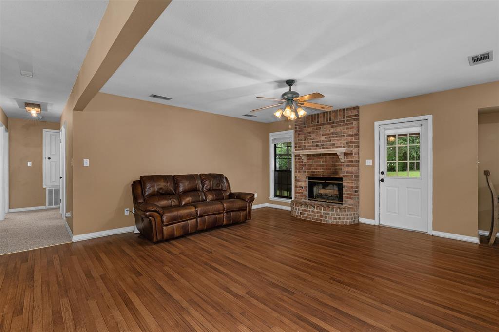 9720 Locust Hill Road Greenwood, LA 71033 - Photo 11 of 31 a living room with furniture and a fireplace
