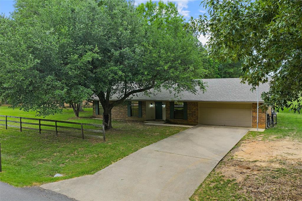 9720 Locust Hill Road Greenwood, LA 71033 - Photo 2 of 31 a front view of a house with garden