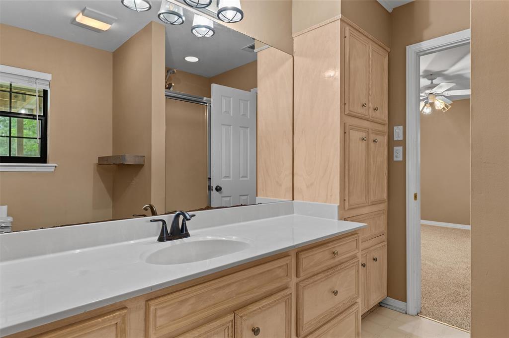 9720 Locust Hill Road Greenwood, LA 71033 - Photo 23 of 31 a bathroom with a sink and a mirror