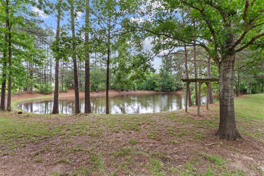 9720 Locust Hill Road Greenwood, LA 71033 - Photo 30 of 31 a lake with a house in the background